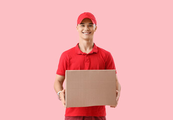 Young courier with parcel on pink background