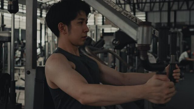 Man exercising in the gym, Intense Arm Muscle Building, Bodybuilder Increases pec deck fly machine at the Gym, Sculpting Strong Biceps.