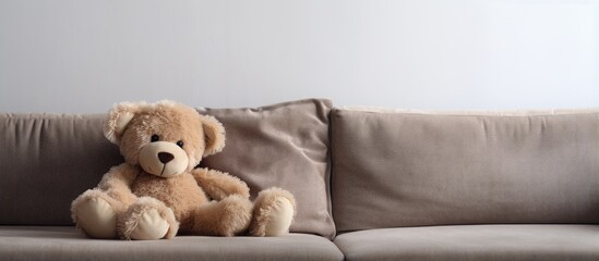 Teddy bear resting on couch