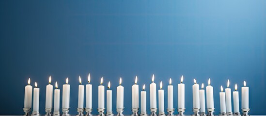 A white menorah adorned with blue and white candles