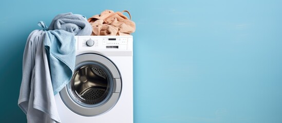 Close up of laundry on blue wall background with washing machine