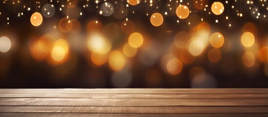 Blurred bokeh lights background at an empty wooden holiday table seen at night