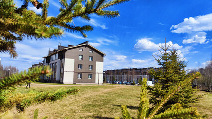 New house on the street in small village or town in a spring or atutumn day. Landscape with...