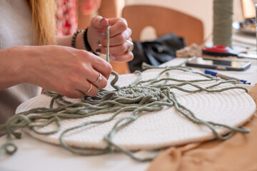 Obraz premium Woman's hands weave macrame decor. Handicrafts advertisement. Copy space