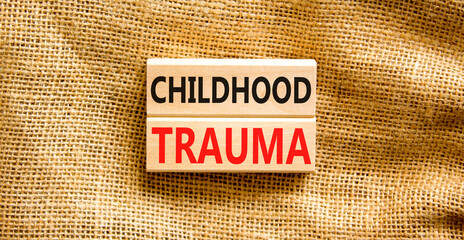 Childhood trauma symbol. Concept words Childhood trauma on beautiful wooden blocks. Beautiful...