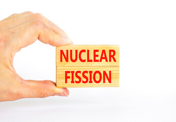 Nuclear fission symbol. Concept words Nuclear fission on beautiful wooden blocks. Beautiful white...