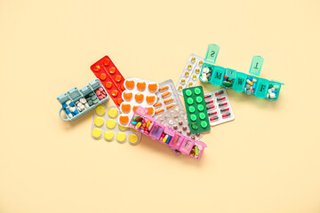 Blister packs and containers with different pills on yellow background