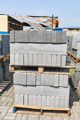 concrete curbstones stacked on pallets outdoor of workshop