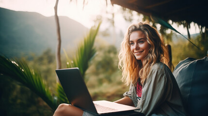 Young woman lifestyle digital nomad working on the laptop hammock at the beach sunset time