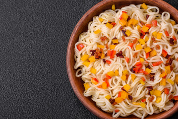 Delicious fresh Asian noodles with pieces of vegetables, meat, with salt, spices and herbs