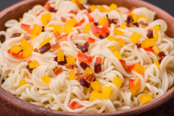 Delicious fresh Asian noodles with pieces of vegetables, meat, with salt, spices and herbs