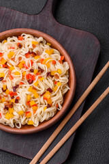 Delicious fresh Asian noodles with pieces of vegetables, meat, with salt, spices and herbs