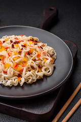 Delicious fresh Asian noodles with pieces of vegetables, meat, with salt, spices and herbs