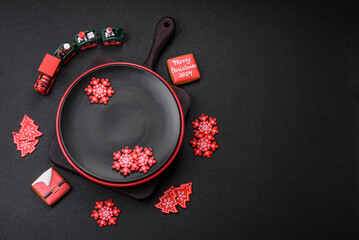 Empty ceramic black plate with christmas decoration elements