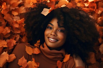 Beautiful smiling black woman walking in the park with autumn leaves, fashion