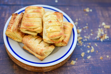 Fresh baked home made  Mini cheese puff pastries and cream  spread cheese.Cheese pie with phyllo pastry and herbs