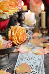 Romantic table decoration with roses and candles. Valentine's Day decorating ideas.