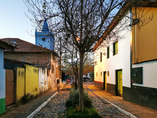 Empty village street with historic houses with lighted lamp posts at dusk in the city of Silveiras, São Paulo, Brazil.