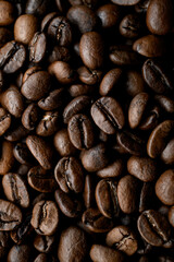Top view of halves of dark brown coffee beans with pleasant scent. Copy space