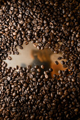 Freshly roasted coffee beans on metallic surface, top view. Coffee beans background