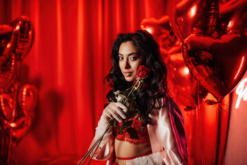 Portrait of smile sexy asian girl glam makeup in lace lingerie and fishnet gloves with red roses
