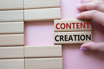 Content creation symbol. Concept word Content creation on wooden blocks. Businessman hand. Beautiful pink background. Business and Content creation concept. Copy space