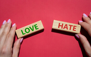 Love vs Hate symbol. Concept word Love vs Hate on wooden blocks. Businessman hand. Beautiful red background. Business and Love vs Hate concept. Copy space