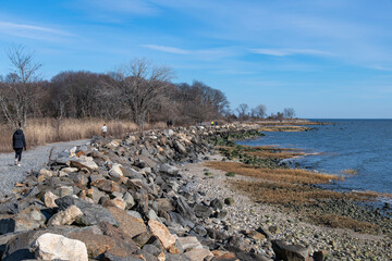 View along the shoreline of Greenwich Point or Tod’s Point, Greenwich, CT, USA with people...