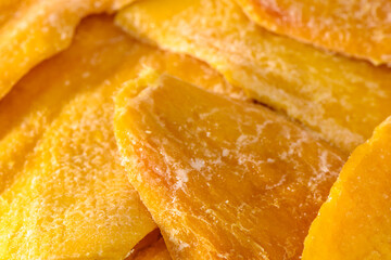background of sliced ​​appetizing dried mango on a white background, studio shot