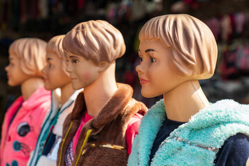 Mannequins at an outdoor market.