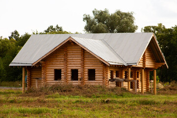 Log house under construction. Wooden house in the village without windows during construction in the summer