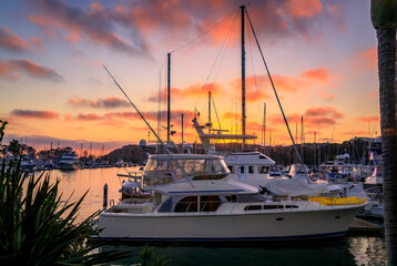 Sunset over luxury yachts and boats in Dana Point harbor, Orange county in Southern California - obrazy, fototapety, plakaty