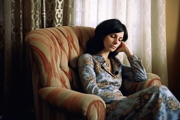 Fototapeta premium Relaxing in Comfort - Middle-Aged Woman Resting in Easy Chair