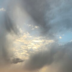 Naklejka na ściany i meble A cloudy sky with sun rays