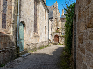 Fototapeta na wymiar A street of Moncontour near a church in Brittany, France