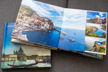 Family photos archive saved in brightly designed photo book; bright summer memories placed in the...