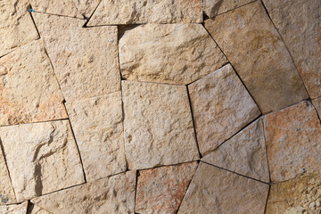 A wall of granite stones as a background.