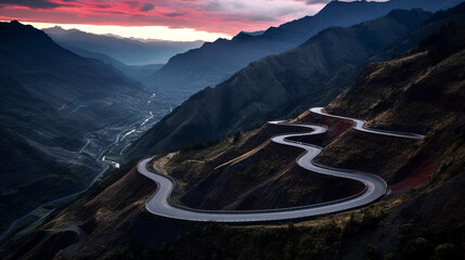 Beautiful aerial panoramic landscape view of a highway in mountains during a evening sunset