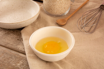 Egg yolk inside a white ceramic bowl