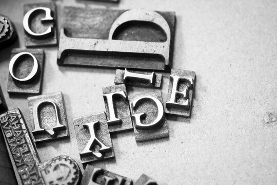 Antique printing press letters close-up metallic  color Czech language