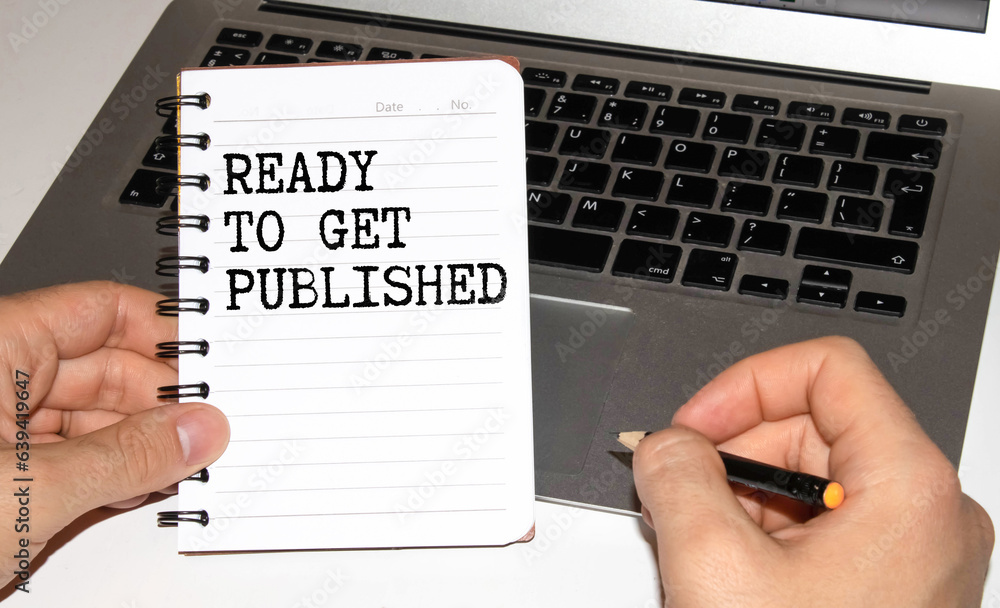 Poster ready to get published text written on notepad with pen on financial documents,