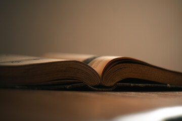 Book, old novel book, hardback cover open on a table, reading literature