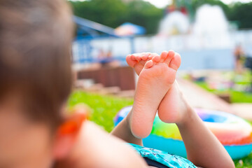 Children's healthy clean feet on the background of the water park - 639423642