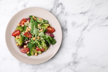 Healthy meal. Tasty salad with quinoa, chickpeas and vegetables on white marble table, top view with space for text