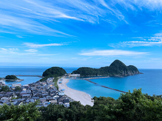 青い空と海、白い雲が風に吹かれて、山の緑も美しい海岸沿いの風景