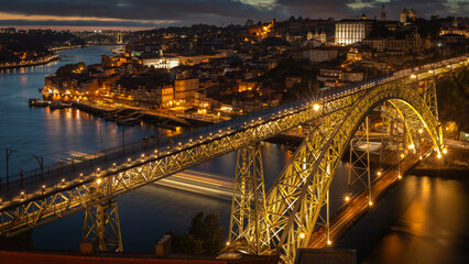 Fototapeta na wymiar Famous Dom-Luis bridge illuminated in Porto at night on Portugal, in August 2023