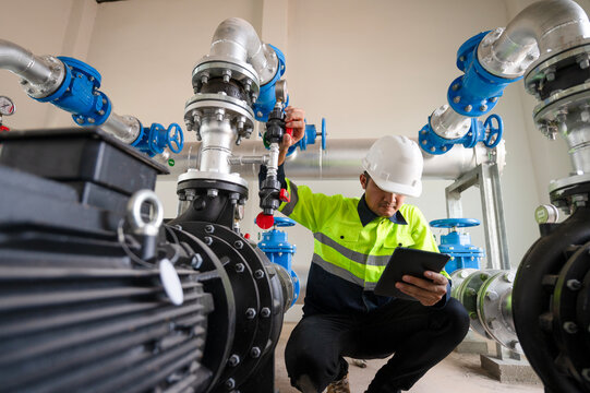 Maintenance engineers inspect the system of pumping stations and pipes delivering clean water and water storage tanks for the community.