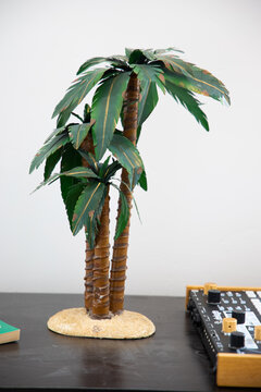 Metal Palm Tree Sculpture Sitting On A Table