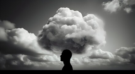 The silhouette of a man's profile head, with a background of dark, expansive clouds. mental health, imagination concept. 