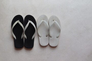 two pairs of sandals on the cement floor